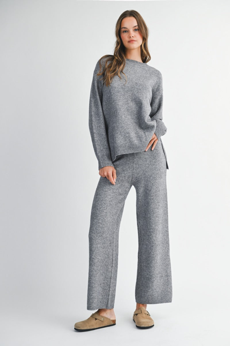 Long sleeve crew neck knit sweater top with side slit detail and matching long pants set.